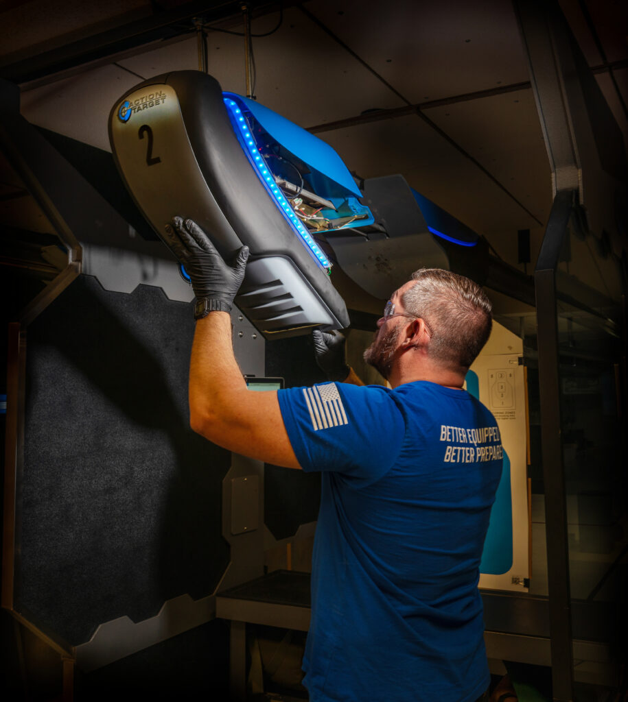 An Action Target technician opening up a Genesis target retriever to conduct maintenance