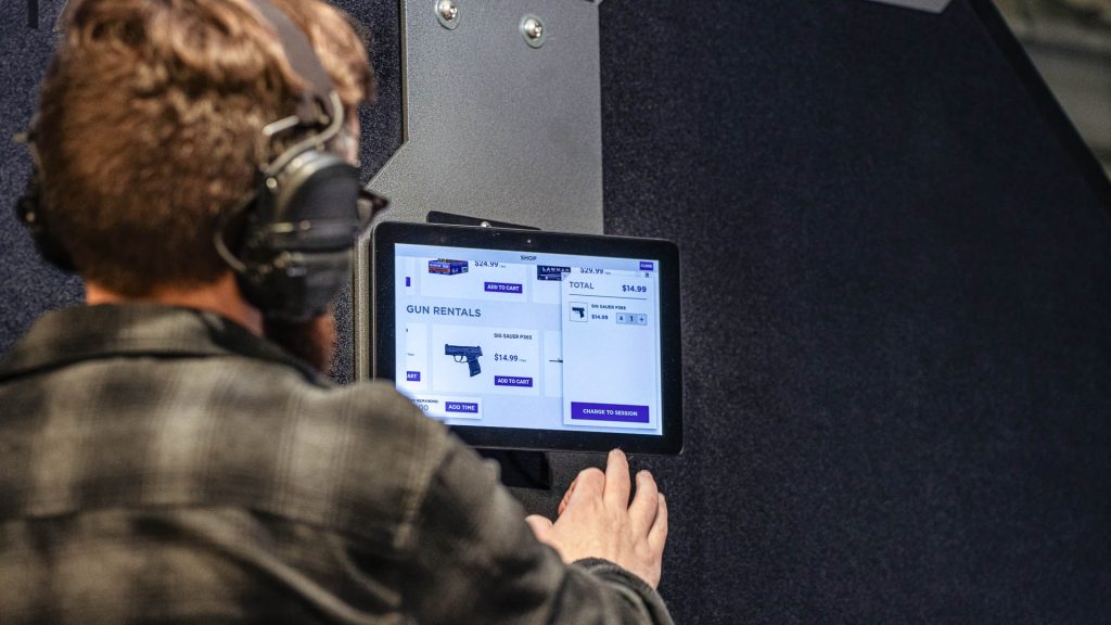Shooter at a lane stall using the in-stall POS purchasing interface