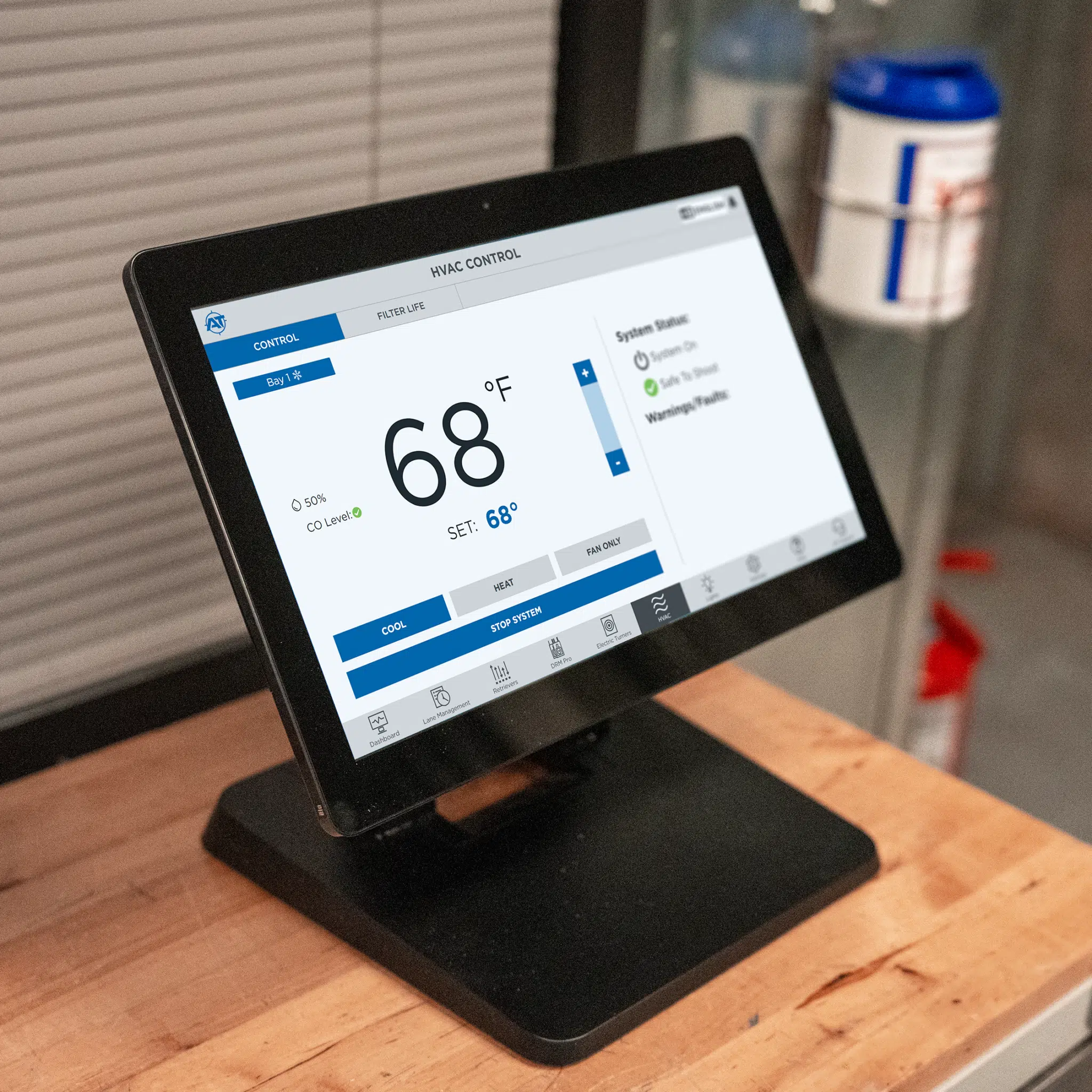 Touchscreen HVAC control panel displaying temperature, CO₂ levels, and system settings for indoor range environment.
